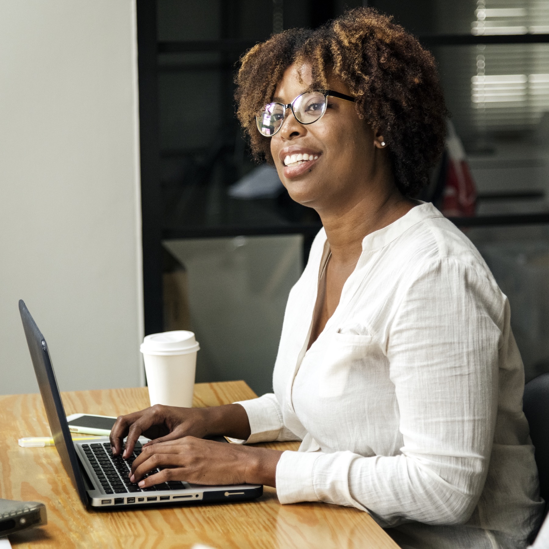 A professional working on a laptop in a meeting room